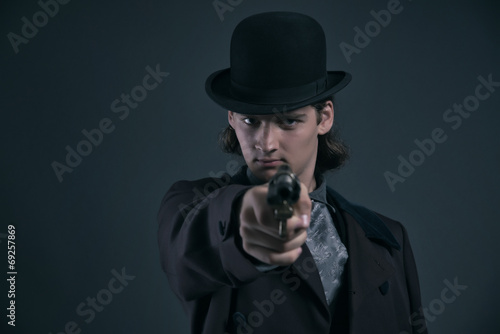 Shooting western 1900 fashion man with brown hair and hat. Studi