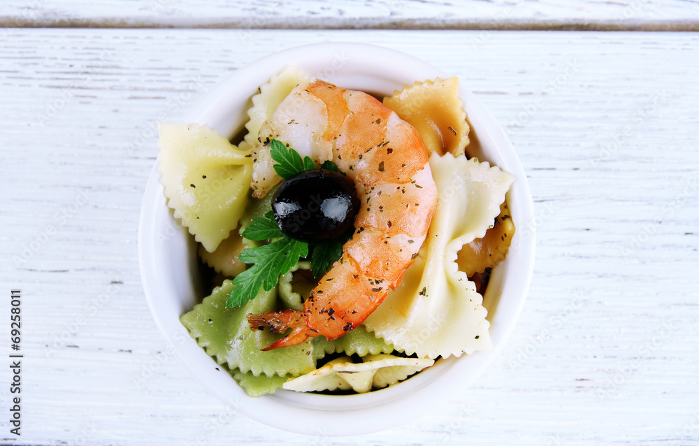 Fresh prawns with coloured macaroni and olives in a round bowl Fresh prawns with coloured macaroni and olives in a round bowl