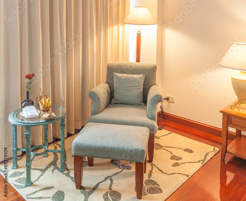 Relaxing corner, Reclining armchair, ottoman and table in hotel photo