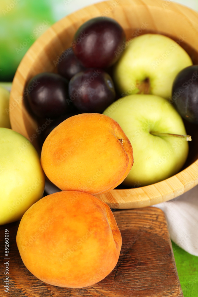 Ripe fruits in bowl on table close up Ripe fruits in bowl on table close up
