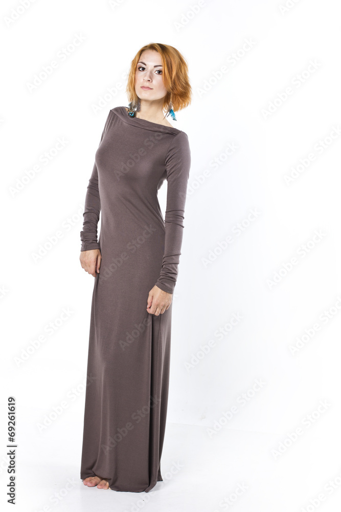 beautiful red-haired young woman in a long evening dress