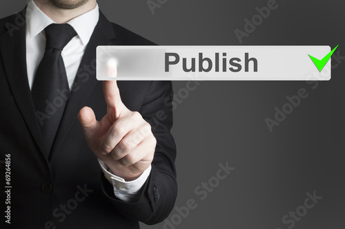 businessman pushing button publish broadcast