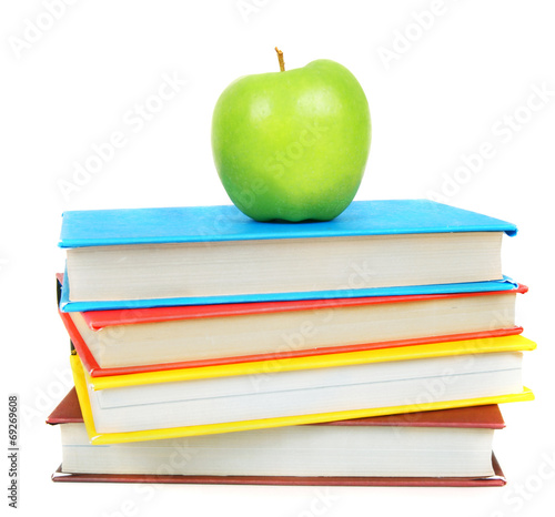 Books and an apple. On white background.