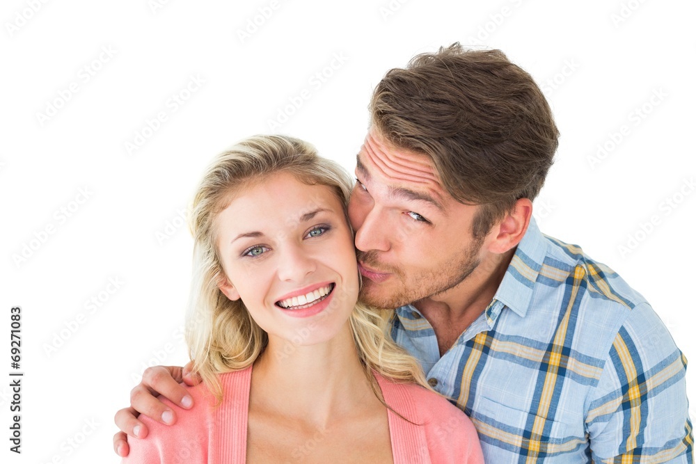 Handsome man kissing girlfriend on cheek Handsome man kissing girlfriend on cheek