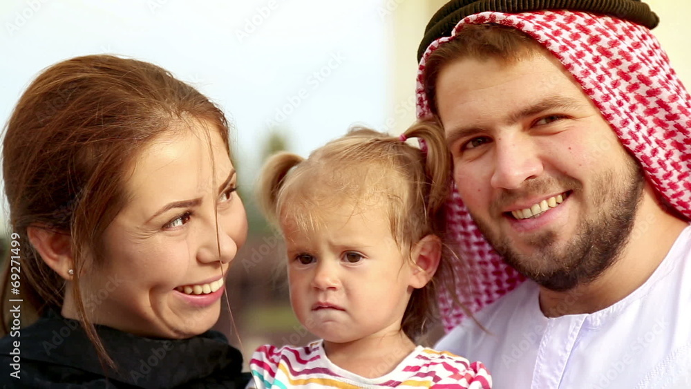Happy Arab family smiling at the camera. Happy Arab family smiling at the camera.
