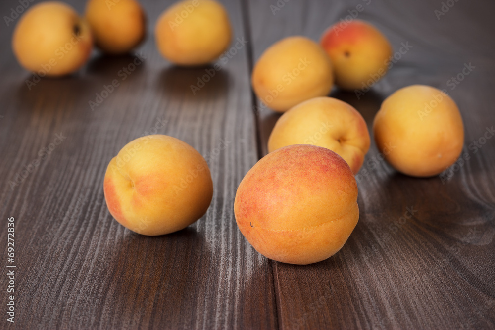 some fresh apricots on brown table
