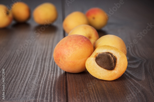 some fresh apricots over wooden background