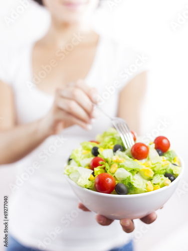 Young woman & vegetable salad isolated in white