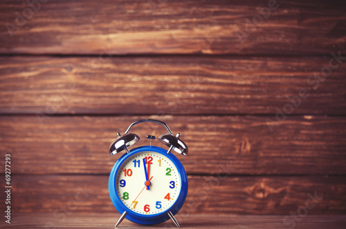 Retro alarm clock on wooden background