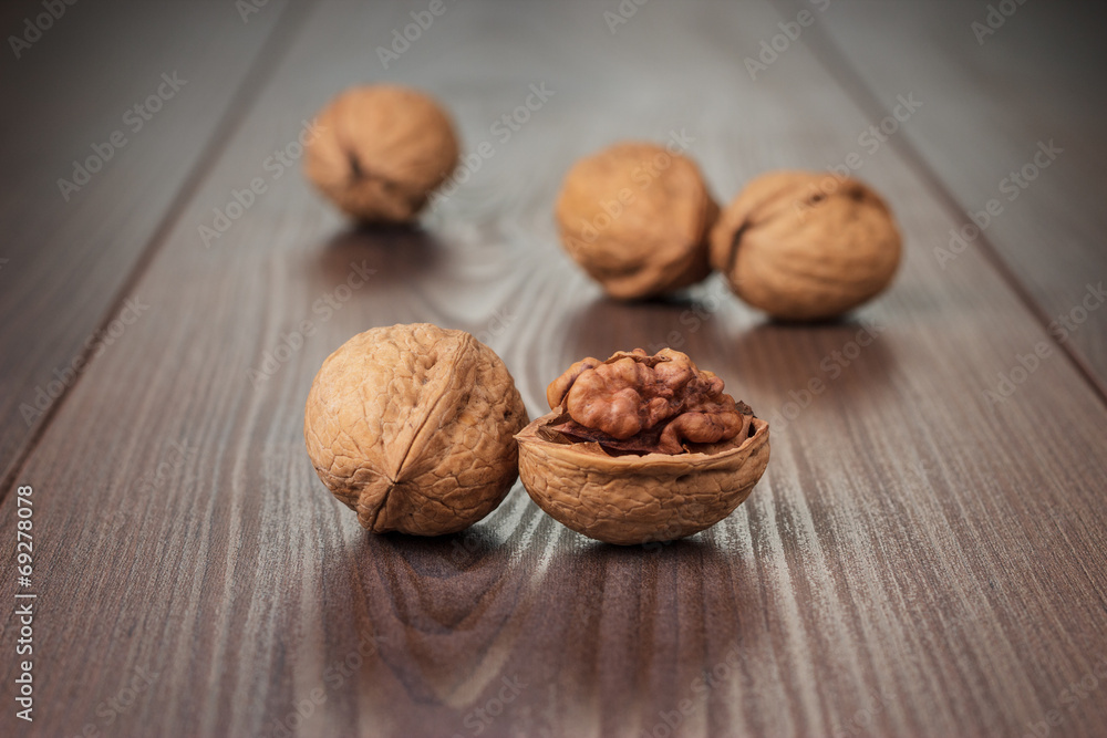 walnuts on the brown wooden table walnuts on the brown wooden table