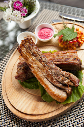Pork ribs on wooden plate