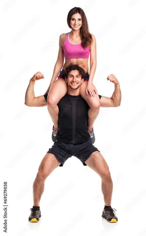 Sports guy holds on shoulder a girl on a white Sports guy holds on shoulder a girl on a white