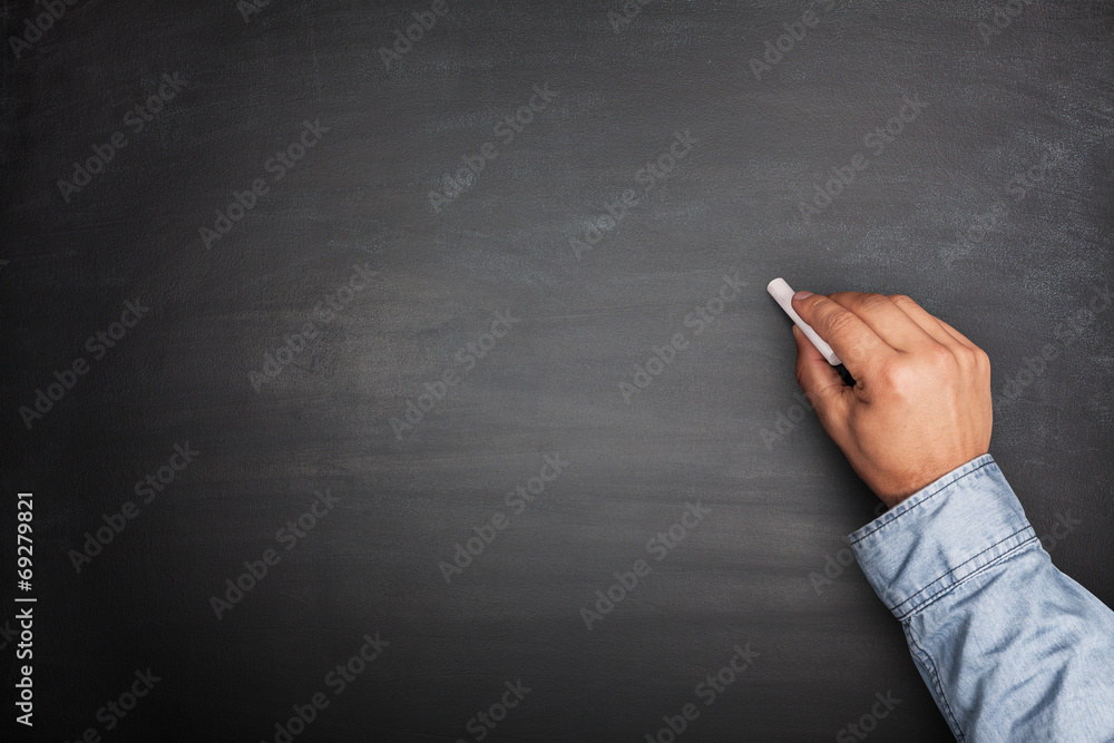 Fototapeta premium Hand on Empty Blackboard