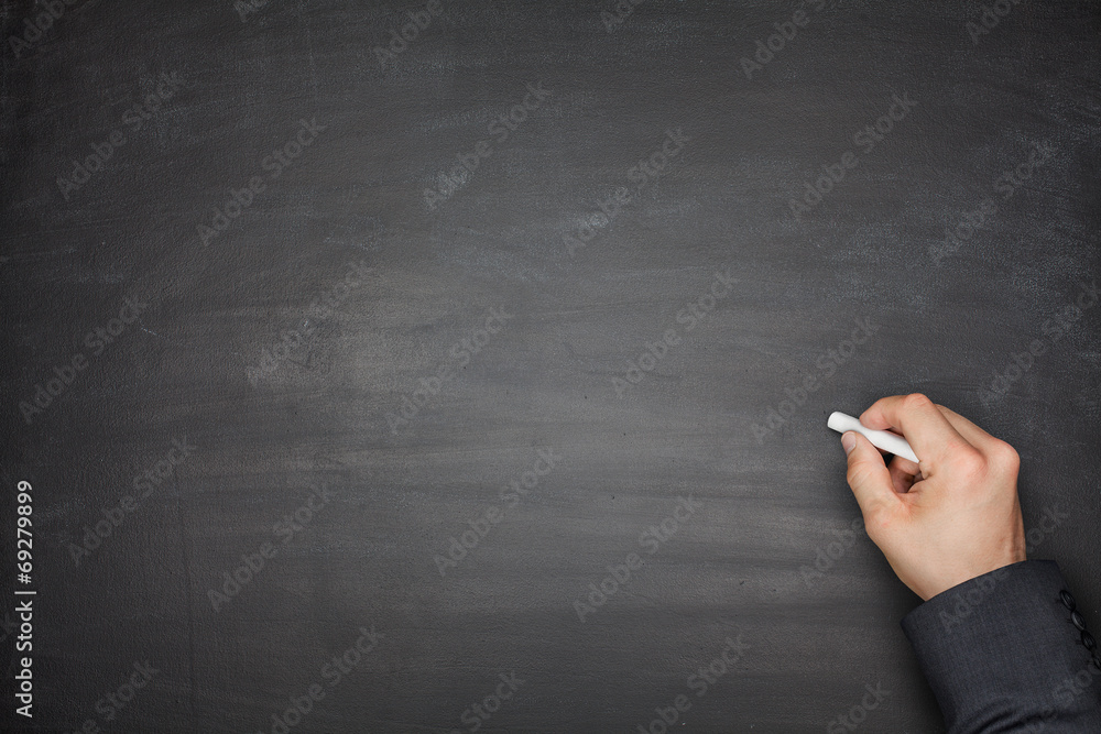 Naklejka premium Hand on Empty Blackboard