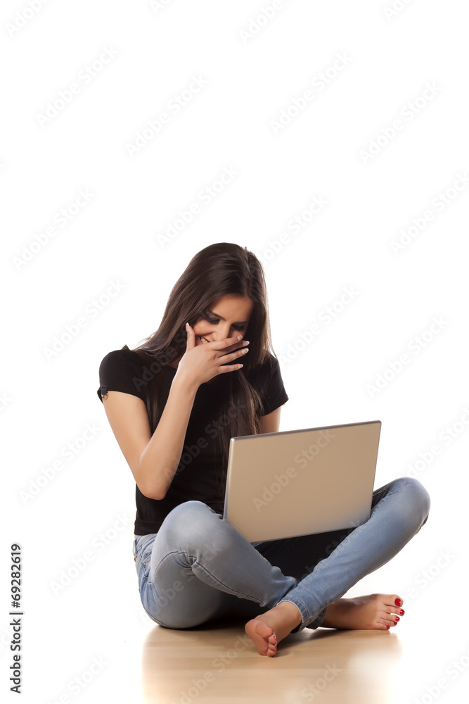 smiling girl sitting on the floor and working on laptop smiling girl sitting on the floor and working on laptop