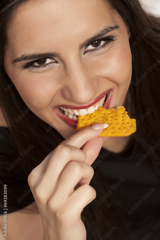 portrait of a smiling girl eating a cracker portrait of a smiling girl eating a cracker