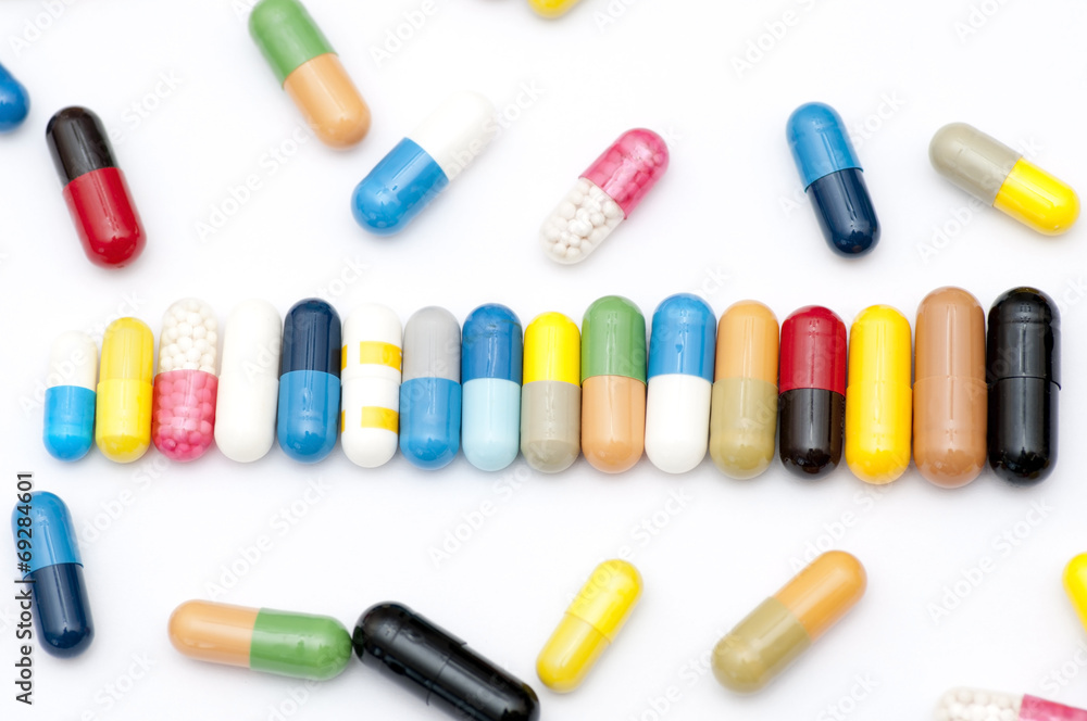 Assortment of capsules in row close up Assortment of capsules in row close up