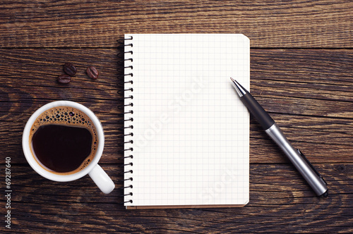 Cup of coffee and notepad photo