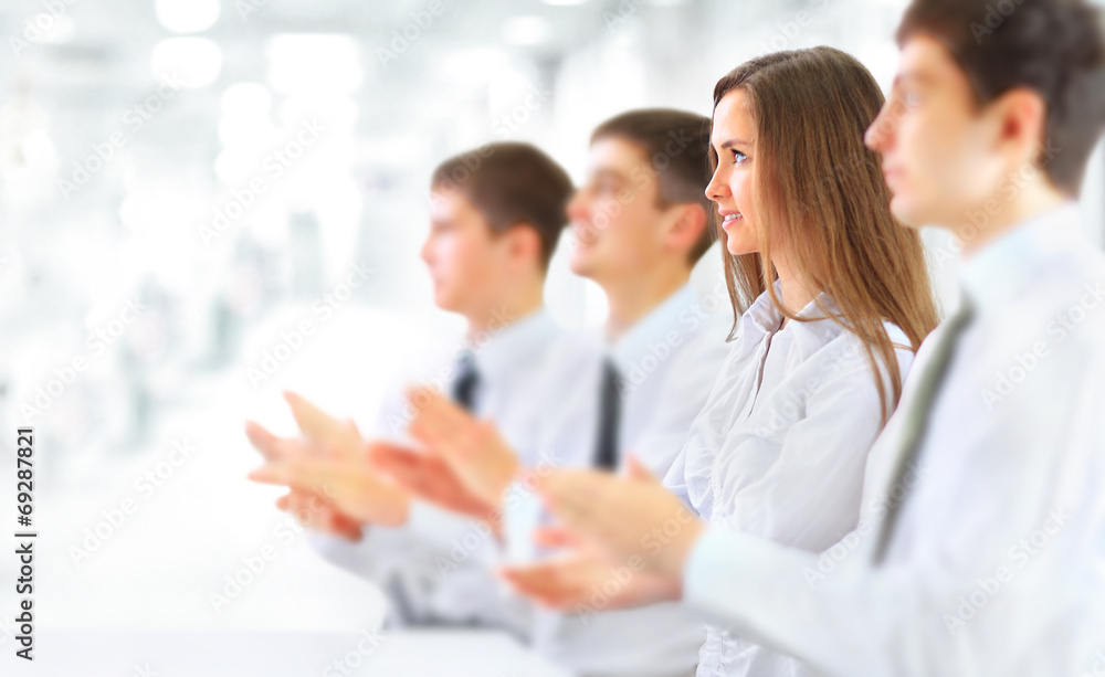 Happy business group applauding at the office Happy business group applauding at the office
