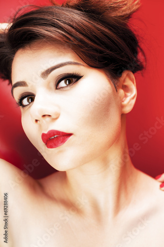 Beautiful young girl on the red background