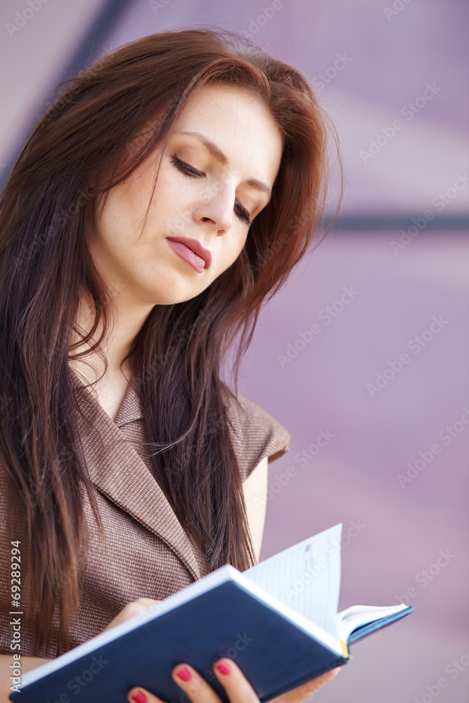 beautiful business woman on the street with blue notepad beautiful business woman on the street with blue notepad
