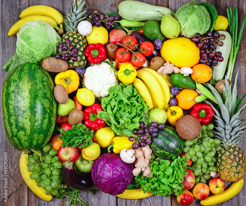 Huge group of fresh vegetables and fruit on wooden background -