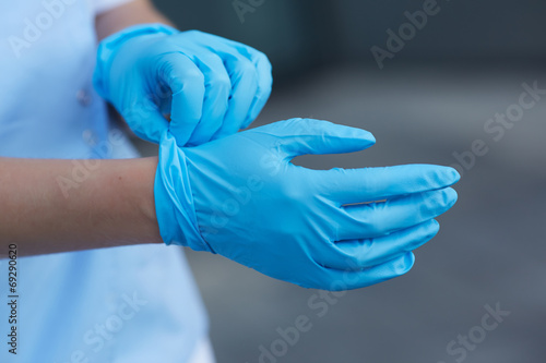woman doctor wears medical gloves