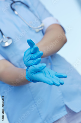 woman doctor wears medical gloves
