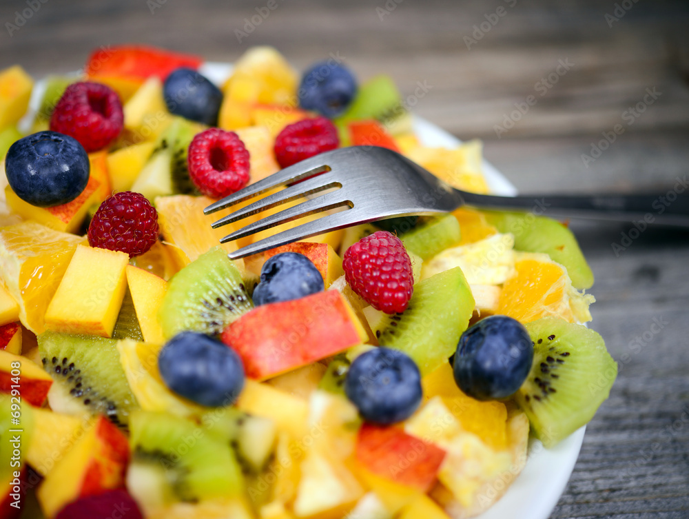 Macro shot of a fresh fruit salad with bananas kiwi orange blueb Macro shot of a fresh fruit salad with bananas kiwi orange blueb