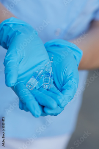female doctor holding a vial
