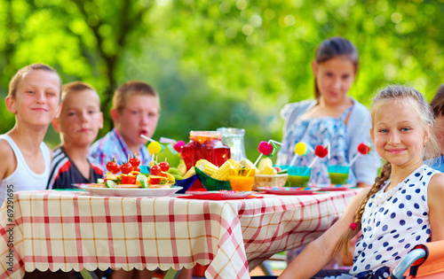 happy kids around picnic table
