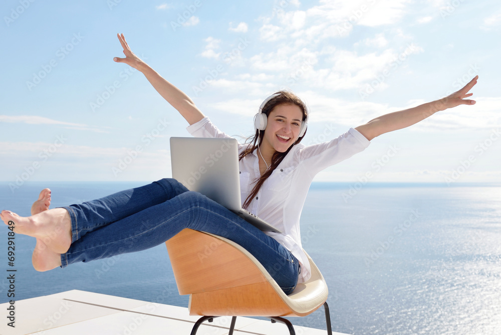 relaxed young woman at home working on laptop relaxed young woman at home working on laptop
