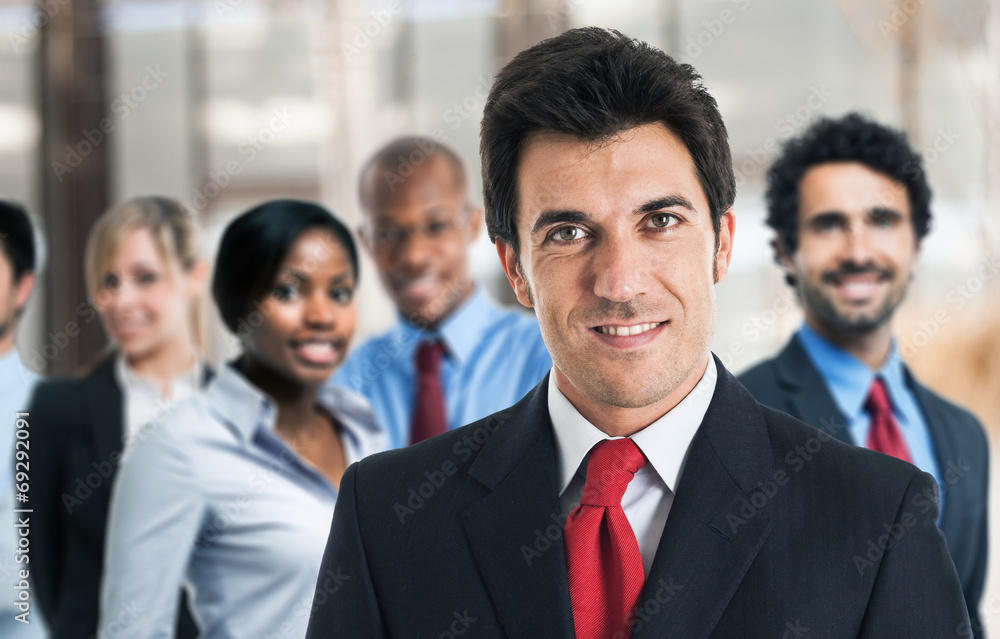 Businessman in front of his team Businessman in front of his team