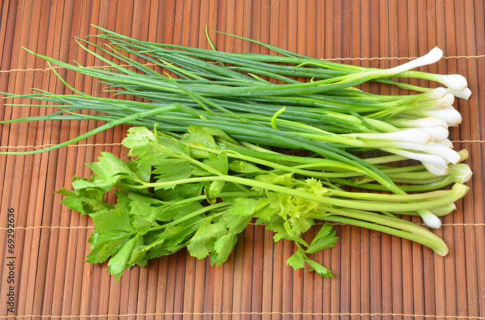 green onions and celery on background green onions and celery on background
