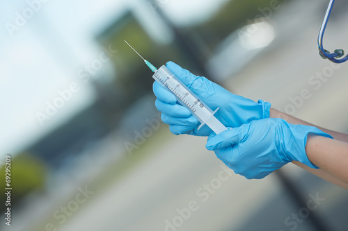 female doctor holding a syringe