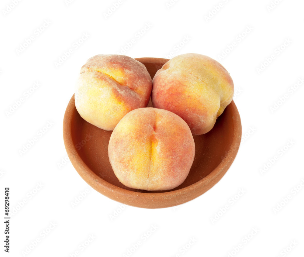 Three Ripe peaches in clay plate Three Ripe peaches in clay plate