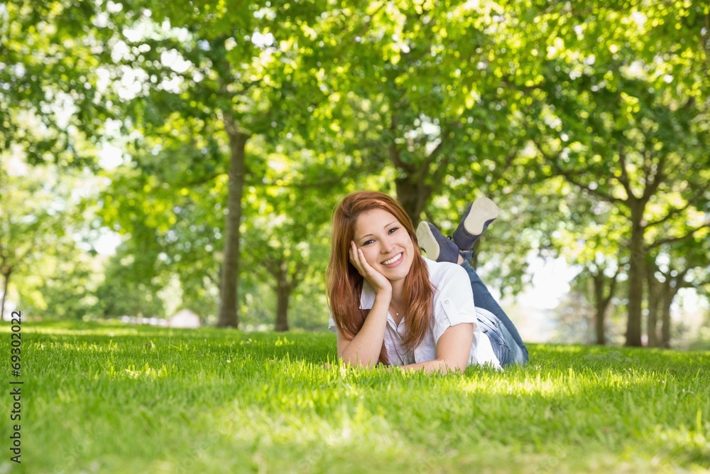 Pretty redhead relaxing in the park