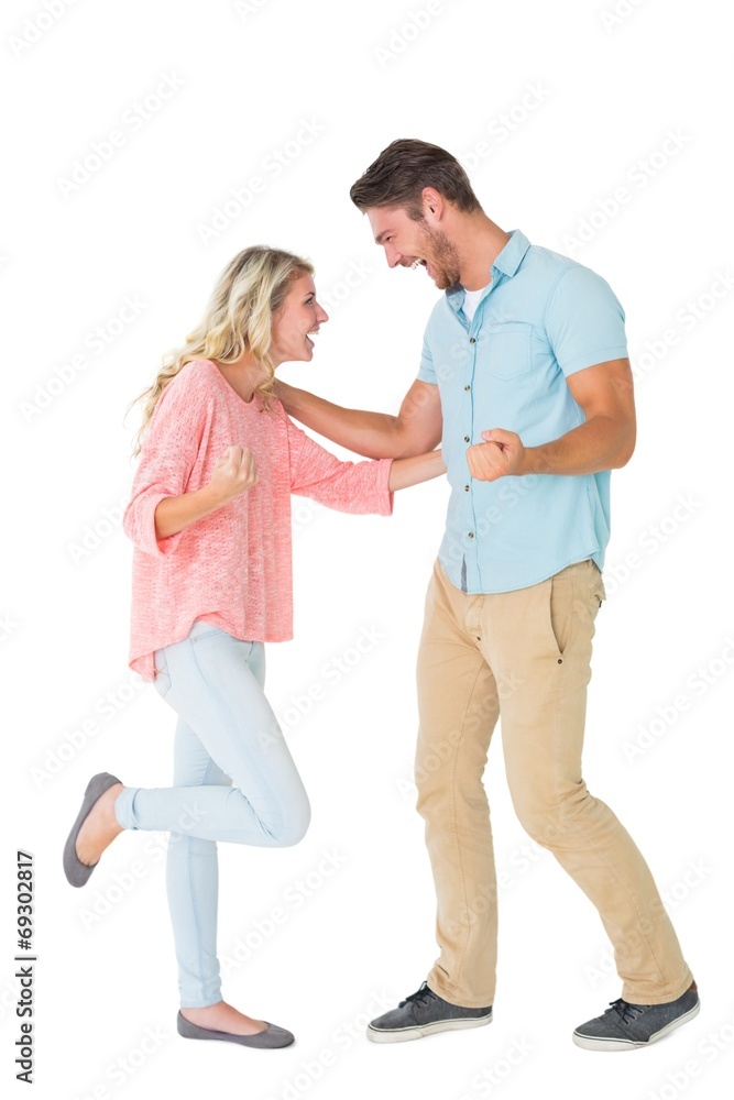 Attractive couple smiling and cheering Attractive couple smiling and cheering