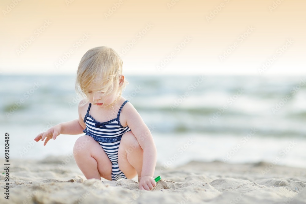 Adorable little girl having fun on a beach Adorable little girl having fun on a beach