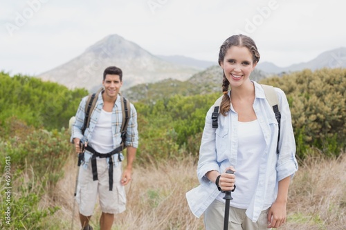 Hiking couple walking on countryside landscape