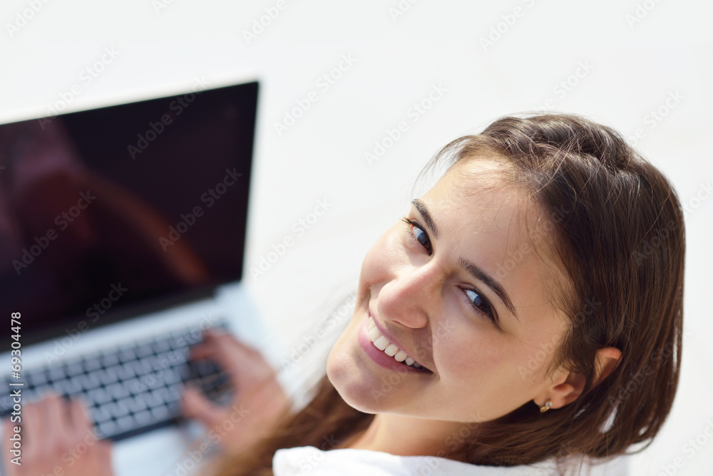 relaxed young woman at home working on laptop computer relaxed young woman at home working on laptop computer
