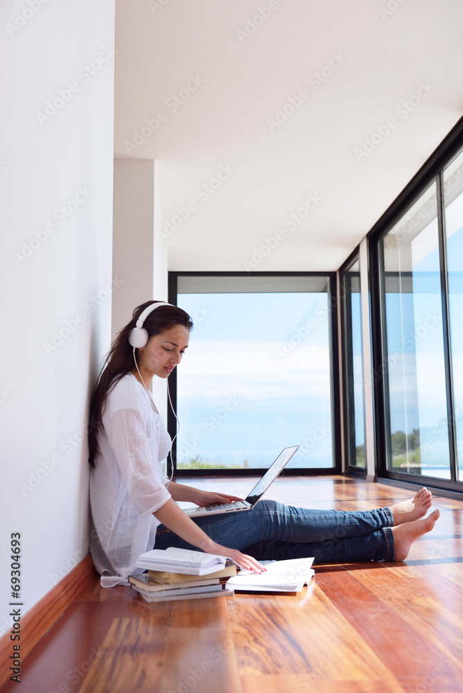 relaxed young woman at home working on laptop relaxed young woman at home working on laptop