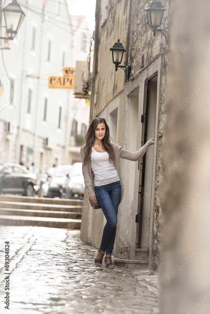 beautiful girl posing in a historic street