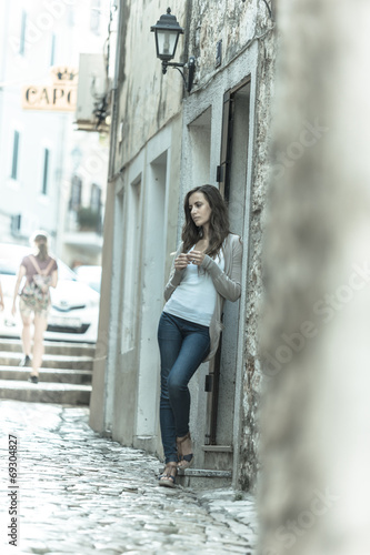 beautiful girl waiting in a historic street