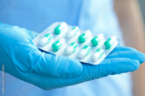 female doctor holding medicine capsules