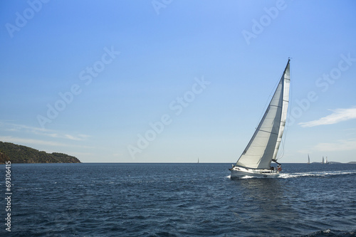 Sailing ship yachts with white sails in the open sea. © De Visu