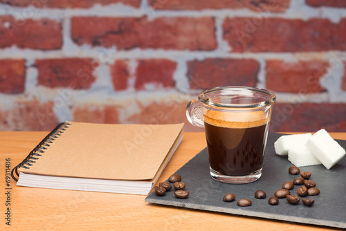 Cup of coffee with notebook photo