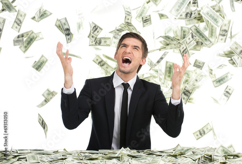 Fotografía Business man throwing dollar bills and yelling.