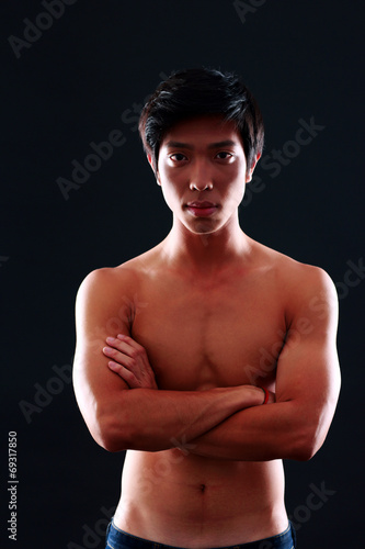 Handsome asian man isolated on black background