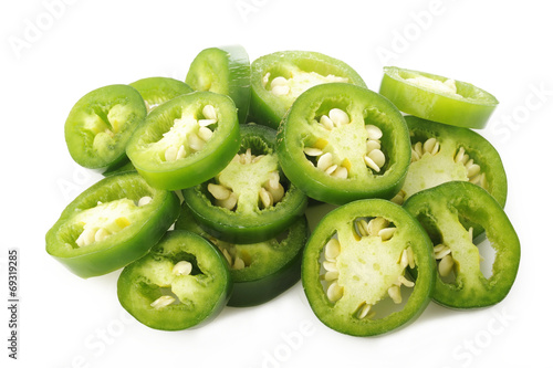 sliced green jalapeno peppers on white background photo
